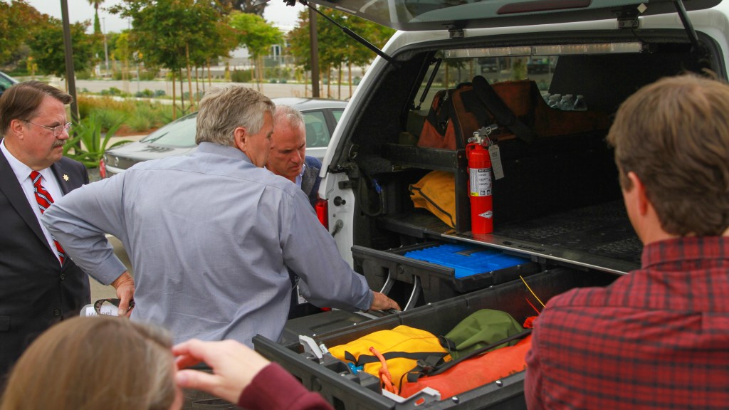 Direct Relief CEO Thomas Tighe, Santa Barbara County Sheriff Bill Brown, and SBC Search and Rescue Commander Nelson Trichler review the new Search vehicle. (Noah Smith/Direct Relief)