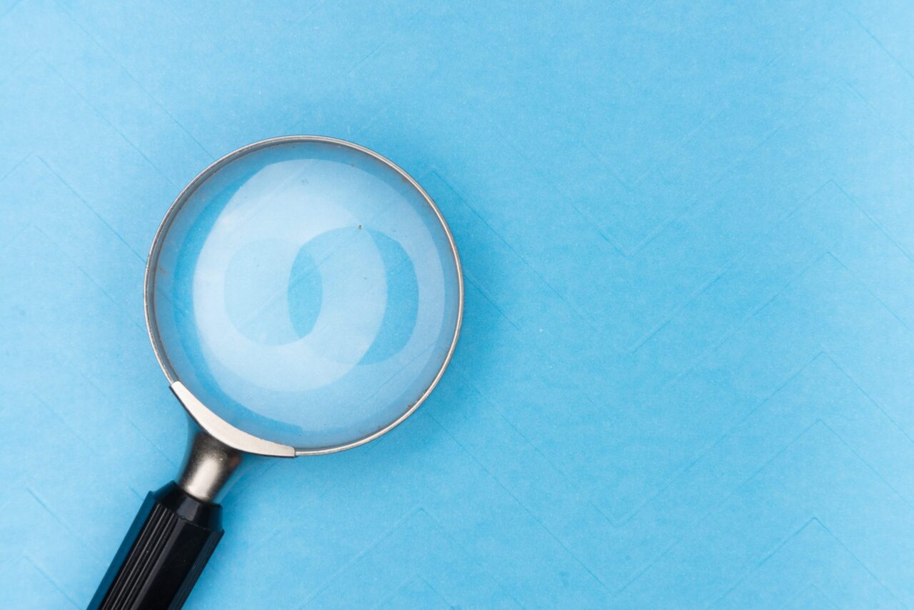 A magnifying glass on a blue background